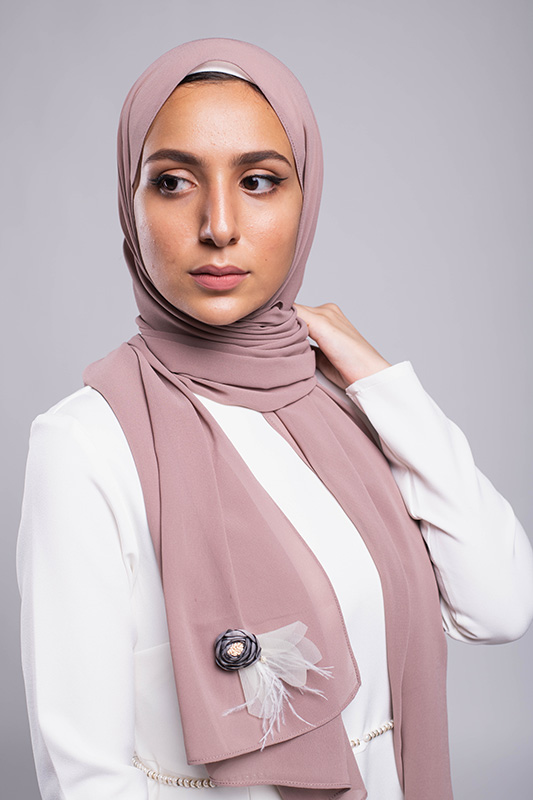 Diva In EMMA Scarf A hijabi model in EMMA Scarf Diva In mauve , with a Satin purple flower embellished on mauve chiffon