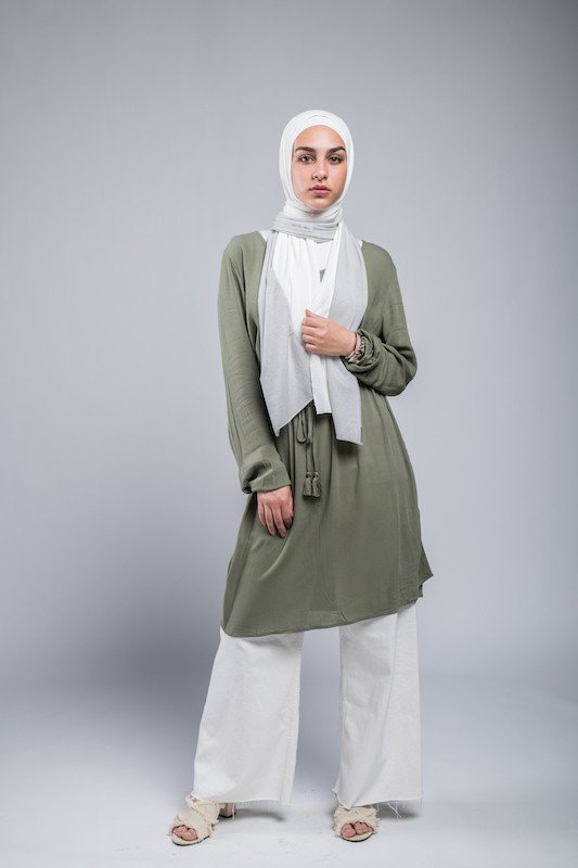 full body shot of hijabi Model in EMMA Scarf Silver Sugar staring at camera with her hand on her chest