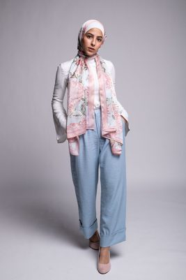 Hijabi Model in EMMA scarf Honey Blooms satin, a print of bees and delicate pink flowers with a pink border.