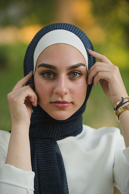 close up of hijabi model in EMMA Scarf Navy Shimmer staring at camera