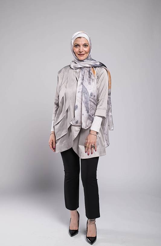 Close up of hijabi woman in EMMA Sarf Galaxy Luna , a grey top and black pants